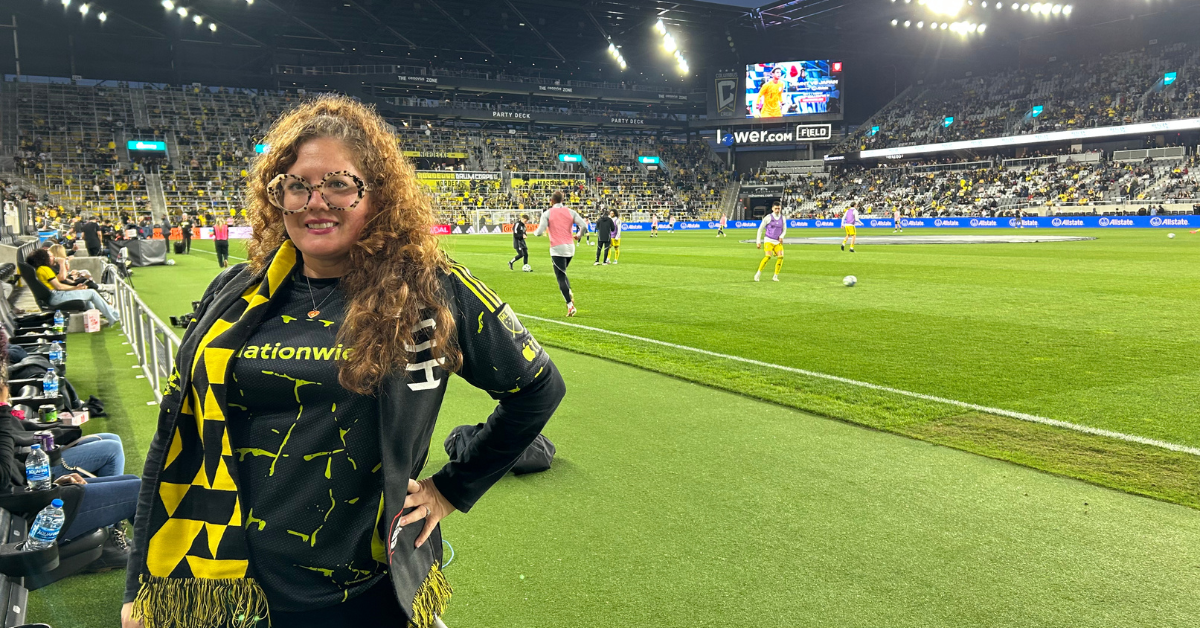 woman standing in front of soccer stadium